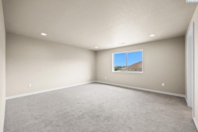 200 Ladera St, Prosser, WA 99350 - empty room featuring carpet floors, recessed lighting, baseboards, and a textured ceiling