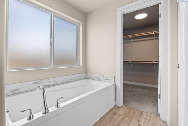 200 Ladera St, Prosser, WA 99350 - full bathroom with a garden tub, wood finished floors, and a walk in closet