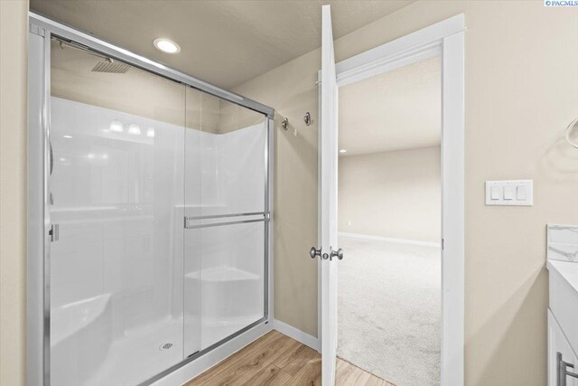 200 Ladera St, Prosser, WA 99350 - bathroom featuring a shower stall, wood finished floors, vanity, baseboards, and recessed lighting