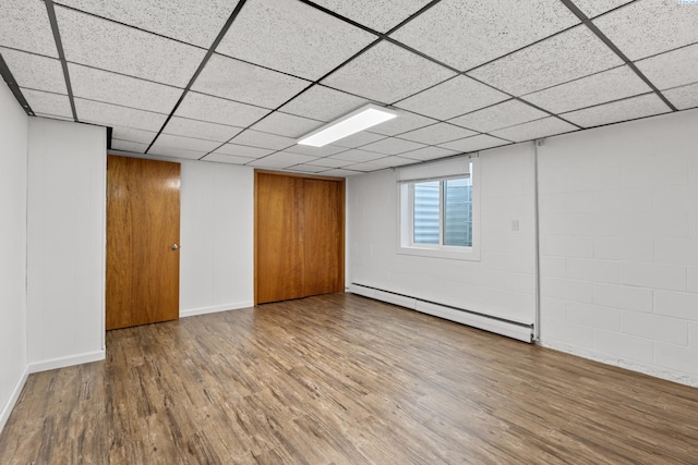 405 W 7th Ave, Ritzville, WA 99169 - basement featuring a drop ceiling, a baseboard heating unit, and wood-type flooring