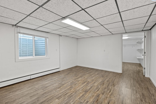 405 W 7th Ave, Ritzville, WA 99169 - empty room with a baseboard heating unit, wood-type flooring, and a paneled ceiling