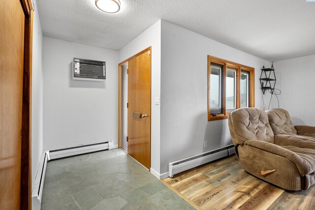 405 W 7th Ave, Ritzville, WA 99169 - sitting room featuring a baseboard heating unit, a textured ceiling, and a wall mounted AC