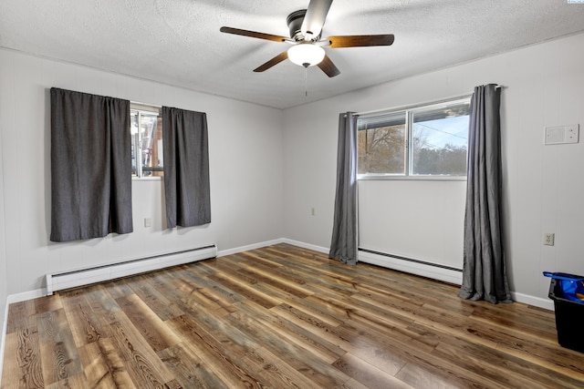 405 W 7th Ave, Ritzville, WA 99169 - spare room with a baseboard radiator, a textured ceiling, and dark hardwood / wood-style flooring