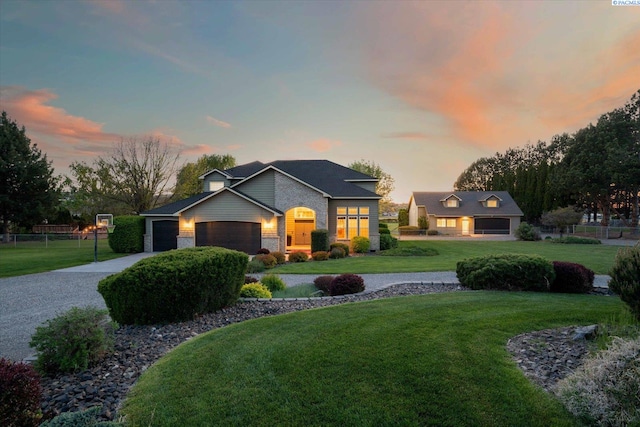 view of front of home with fence, concrete driveway, brick siding, an attached garage, and a lawn