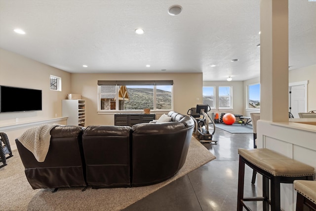 living room featuring concrete floors and a textured ceiling