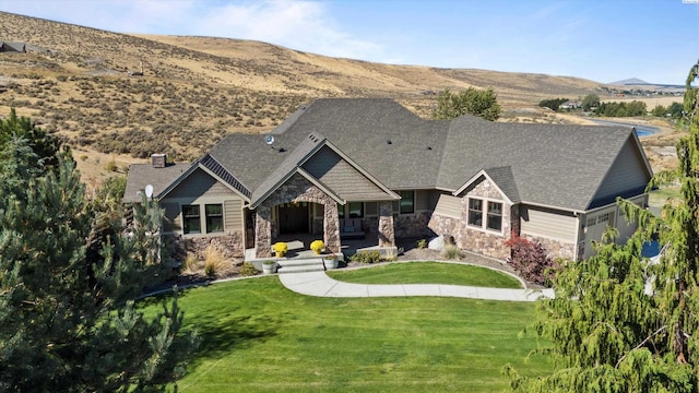 view of front of property with a mountain view and a front yard