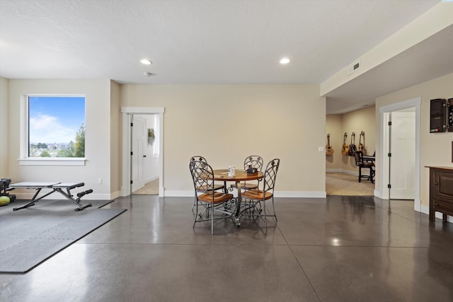 dining space with a textured ceiling