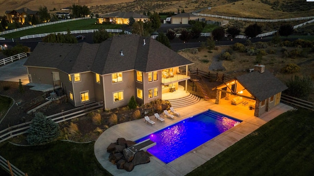 view of swimming pool with a bar, an outbuilding, and a patio area