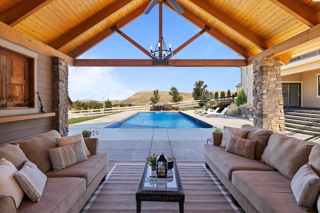 view of pool with a gazebo, outdoor lounge area, a mountain view, and a patio