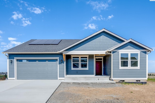 1060 SW Panorama Dr, Pullman, WA 99163 - view of front facade with an attached garage, roof mounted solar panels, covered porch, and driveway