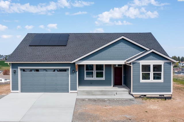 1060 SW Panorama Dr, Pullman, WA 99163 - view of front of house featuring roof with shingles, a porch, solar panels, and driveway