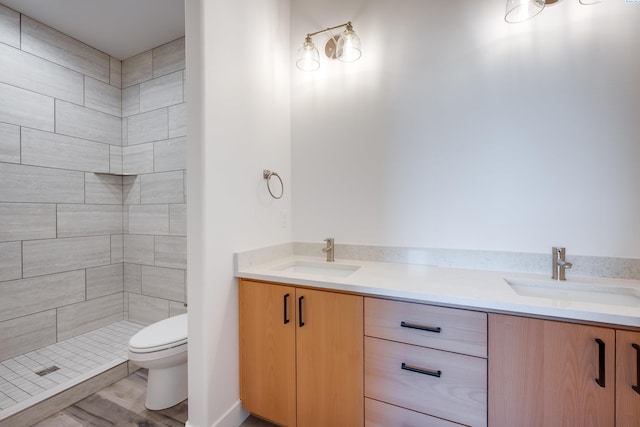 1060 SW Panorama Dr, Pullman, WA 99163 - full bathroom featuring double vanity, toilet, a tile shower, and a sink