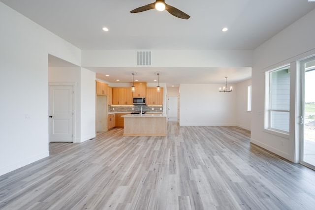 1060 SW Panorama Dr, Pullman, WA 99163 - unfurnished living room with visible vents, baseboards, recessed lighting, light wood-style flooring, and ceiling fan with notable chandelier