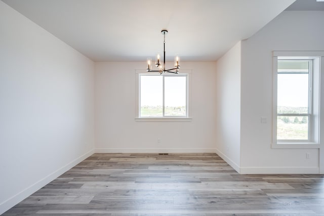 1060 SW Panorama Dr, Pullman, WA 99163 - unfurnished dining area with baseboards, an inviting chandelier, and light wood-style floors