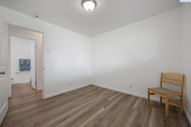 3925 W Okanogan Ave, Kennewick, WA 99336 - empty room with wood finished floors, baseboards, a smoke detector, and a textured ceiling