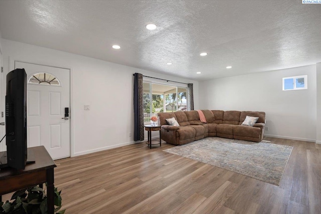 3925 W Okanogan Ave, Kennewick, WA 99336 - living area with a textured ceiling, light wood-style floors, baseboards, and recessed lighting