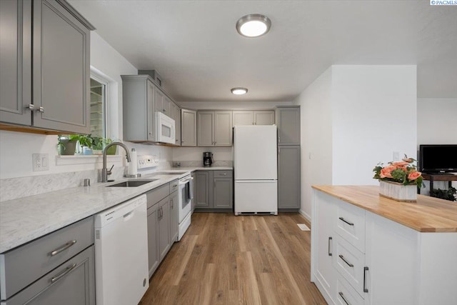 3925 W Okanogan Ave, Kennewick, WA 99336 - kitchen with white appliances, gray cabinets, and a sink