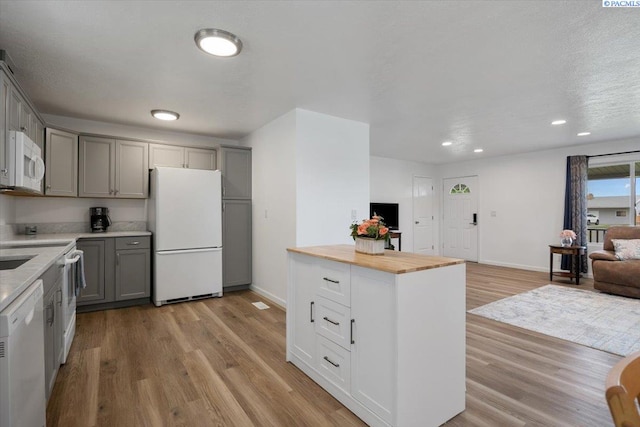 3925 W Okanogan Ave, Kennewick, WA 99336 - kitchen with white appliances, gray cabinets, open floor plan, light wood finished floors, and recessed lighting