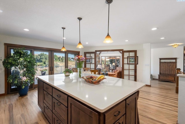 kitchen with recessed lighting, french doors, light countertops, and light wood-style flooring