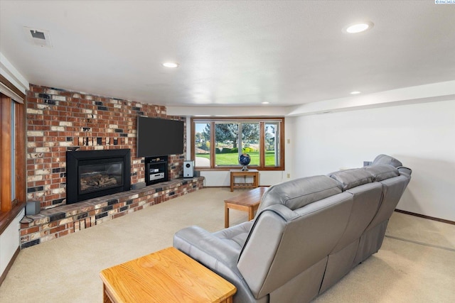 carpeted living area with baseboards, a fireplace, visible vents, and recessed lighting