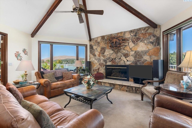 living room featuring carpet, ceiling fan, a stone fireplace, high vaulted ceiling, and beamed ceiling