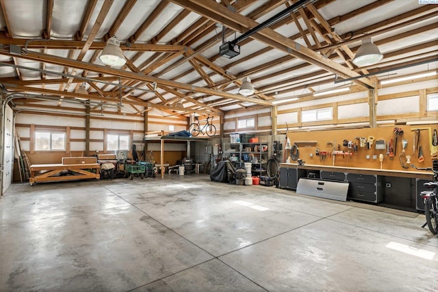 garage with a workshop area and a garage door opener