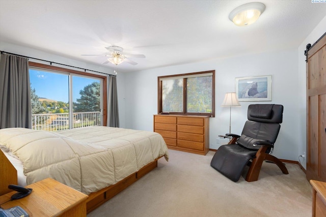 bedroom with a barn door, baseboards, a ceiling fan, light colored carpet, and access to exterior