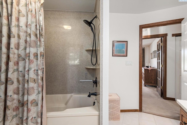 full bath with tile patterned flooring, shower / tub combo with curtain, vanity, and baseboards