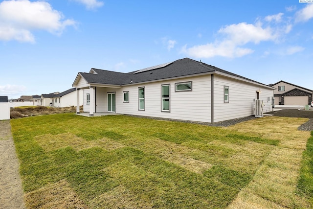 rear view of property featuring a yard