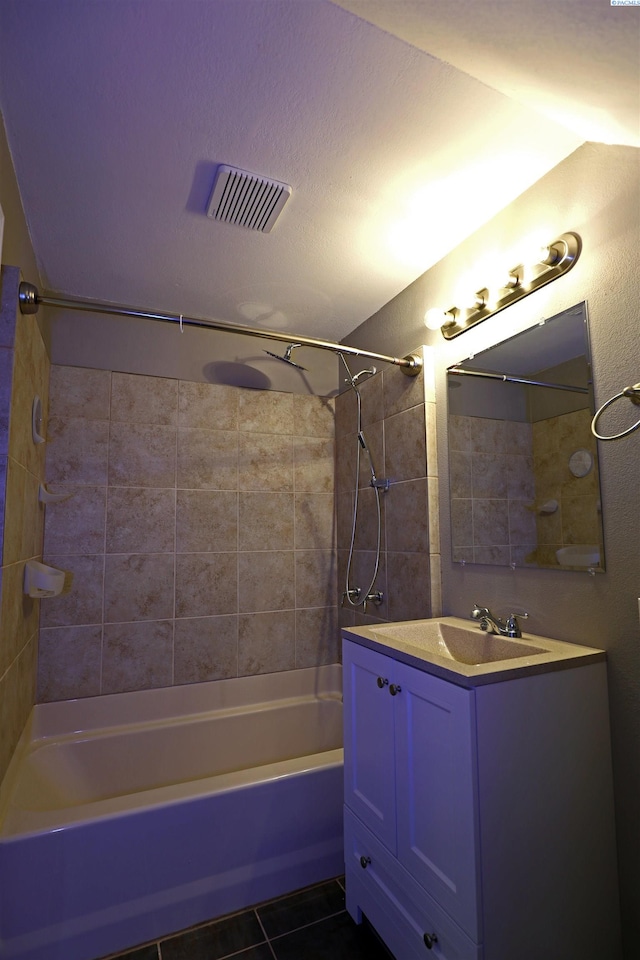 full bath with visible vents, tile patterned flooring, vanity, and bathing tub / shower combination
