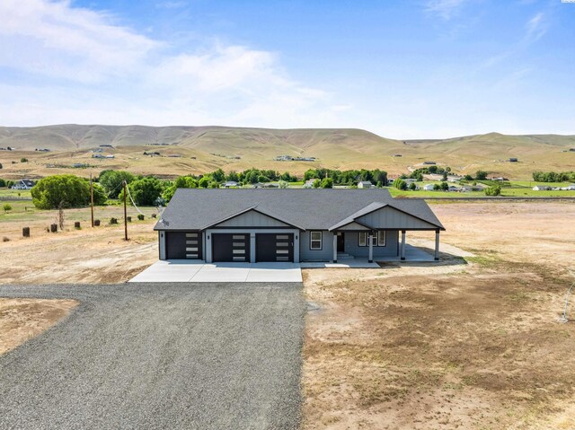 16011 W 1620th Pr NW, Prosser, WA 99350 - view of front of property with a mountain view, driveway, covered porch, and a view of rural / pastoral area