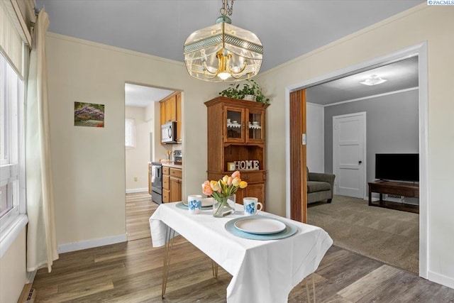 213 Bernard Ave, Richland, WA 99352 - dining area with wood finished floors, crown molding, baseboards, and a chandelier