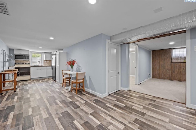213 Bernard Ave, Richland, WA 99352 - kitchen with appliances with stainless steel finishes, a sink, recessed lighting, light wood-style floors, and white cabinetry