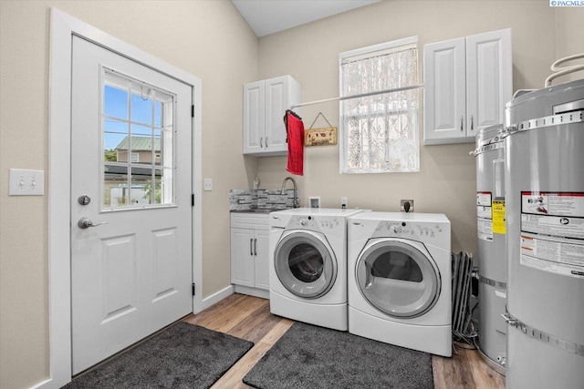 213 Bernard Ave, Richland, WA 99352 - laundry room with separate washer and dryer, cabinet space, light wood-style floors, and secured water heater