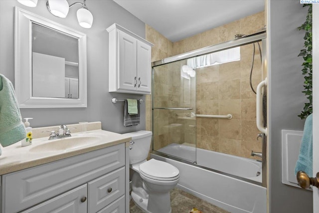 213 Bernard Ave, Richland, WA 99352 - bathroom featuring vanity, toilet, and shower / bath combination with glass door
