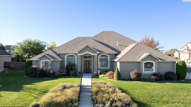 single story home featuring a front lawn