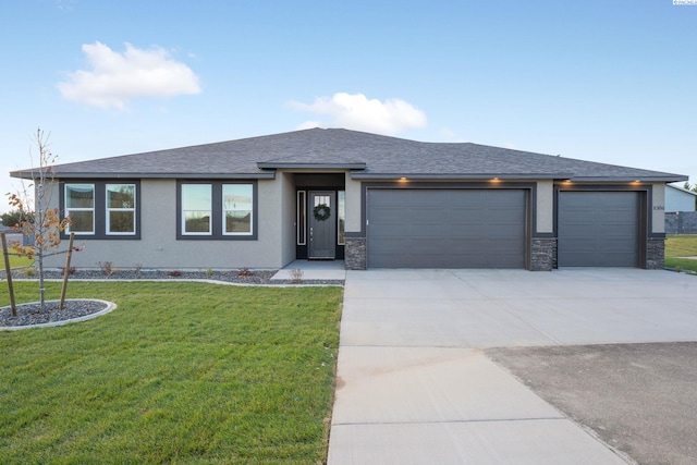 prairie-style home with a garage and a front yard