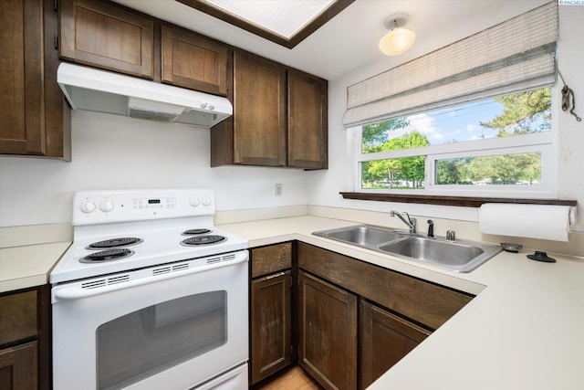 kitchen with white range with electric cooktop, under cabinet range hood, a sink, and dark brown cabinets