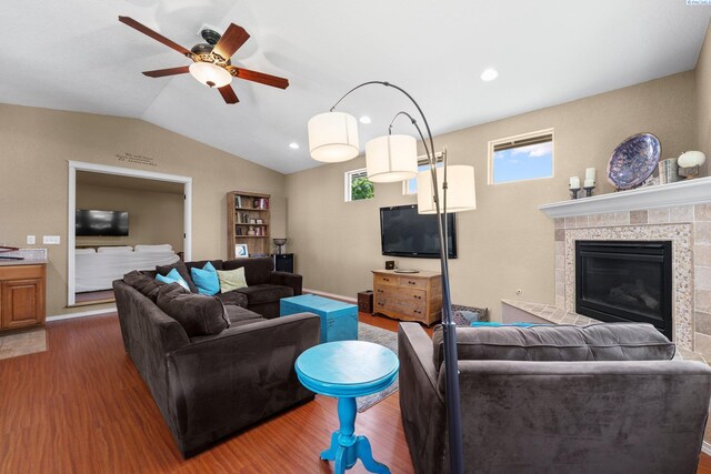 912 Rd 44, Pasco, WA 99301 - living room with wood finished floors, vaulted ceiling, a ceiling fan, and a tiled fireplace