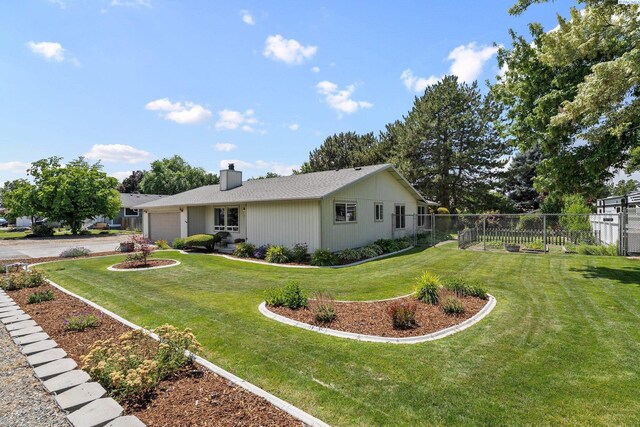 912 Rd 44, Pasco, WA 99301 - view of side of property featuring a garage, a chimney, and driveway