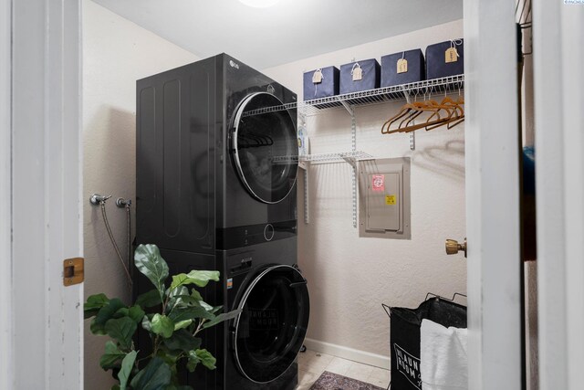 912 Rd 44, Pasco, WA 99301 - washroom featuring stacked washer / dryer, electric panel, and tile patterned flooring