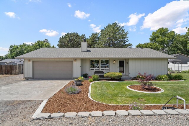 912 Rd 44, Pasco, WA 99301 - single story home featuring a garage, a chimney, driveway, and roof with shingles