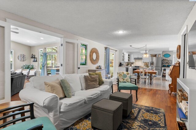 912 Rd 44, Pasco, WA 99301 - living room with hardwood / wood-style flooring, a textured ceiling, and recessed lighting