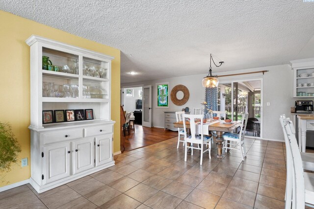 912 Rd 44, Pasco, WA 99301 - dining area with light tile patterned floors, plenty of natural light, and a textured ceiling