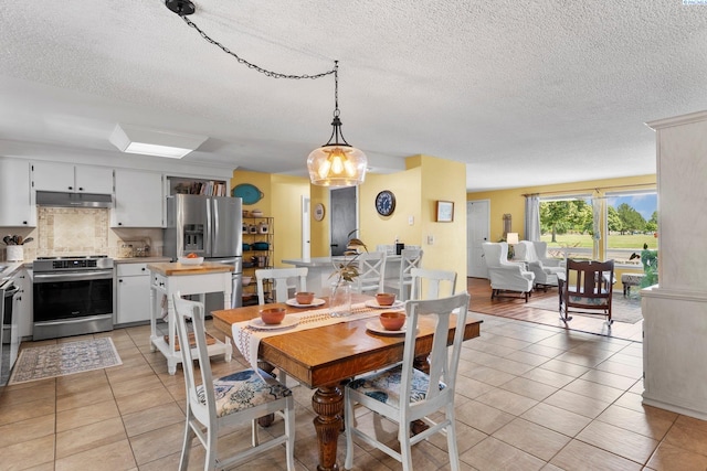 912 Rd 44, Pasco, WA 99301 - dining space featuring a textured ceiling and light tile patterned floors