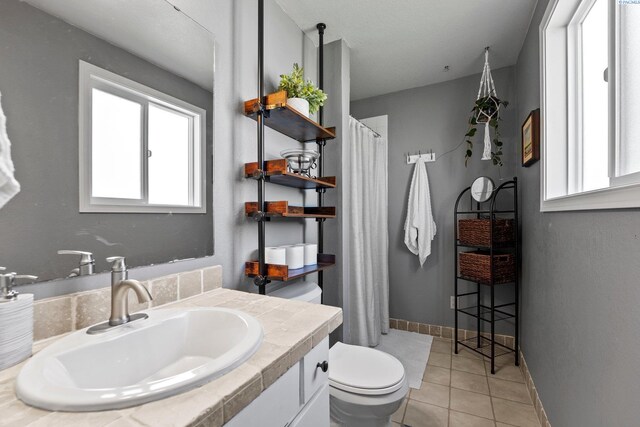 912 Rd 44, Pasco, WA 99301 - full bath featuring vanity, tile patterned floors, and healthy amount of natural light