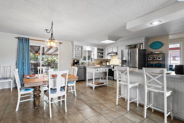 912 Rd 44, Pasco, WA 99301 - dining space featuring a textured ceiling and light tile patterned flooring