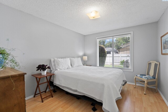912 Rd 44, Pasco, WA 99301 - bedroom with light wood-style flooring and a textured ceiling