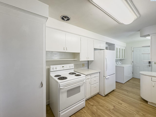 1015 Catherine St, Walla Walla, WA 99362 - kitchen featuring white appliances, separate washer and dryer, white cabinetry, and light countertops