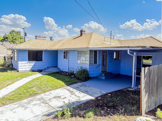 1015 Catherine St, Walla Walla, WA 99362 - ranch-style house with a chimney, entry steps, an attached carport, and a shingled roof